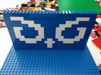 Nate at the library with kids and recreates the BrandHoot logo-mark with legos